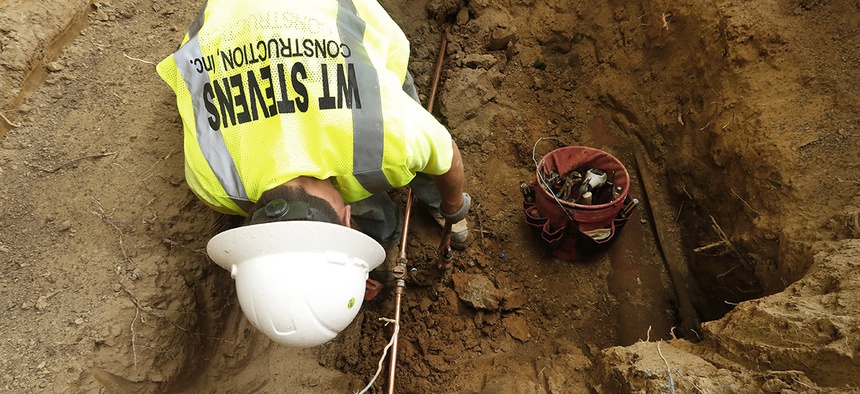 A new copper water supply line is installed at a home during lead pipe replacement in Flint, Mich., Friday, July 20, 2018.