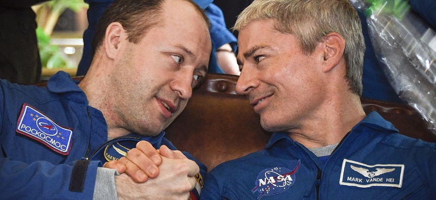 Russian cosmonaut Alexander Misurkin, left, shakes hands with NASA U.S. astronaut Mark Vande Hei during a press conference in the Kazakh town of Zhezkazgan, Kazakhstan, on Wednesday, Feb. 28, 2018.