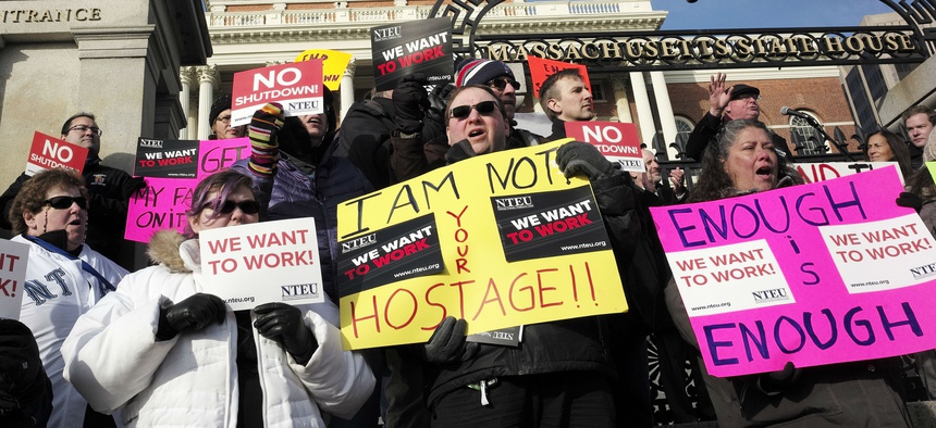 Internal Revenue Service employees call for an end of the partial shutdown of the federal government in front of the Statehouse in Boston Jan. 17.