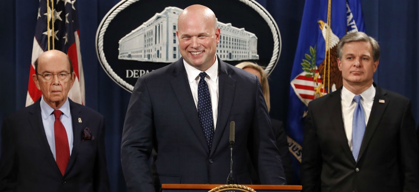 Acting Attorney General Matt Whitaker, center, announces an indictment of Chinese telecommunications companies including Huawei, on violations including bank and wire fraud Jan. 28 at the Justice Department in Washington.