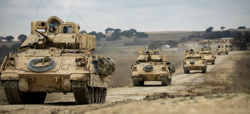Bradley Fighting Vehicles convoy towards their battle positions during the combined arms live-fire exercise Feb. 9.