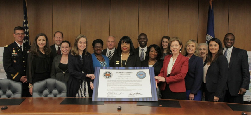 Officials at the signing of a memorandum of understanding between the Office of Personnel Management and the Defense Department May 3.
