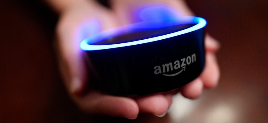 A child holds his Amazon Echo Dot.