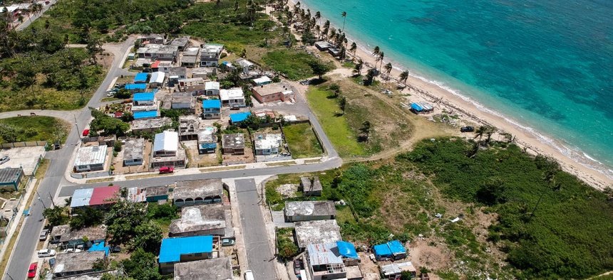 Blue tarps cover homes in Puerto Rico that were still damaged nine months after Hurricane Maria hit.