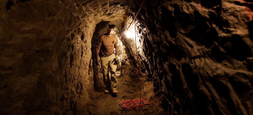 A member of the Border Patrol's Border Tunnel Entry Team walks in a tunnel spanning the border between San Diego and Tijuana, Mexico, in San Diego in 2017.