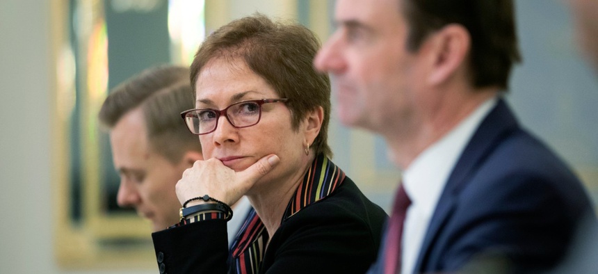 In this March 6, 2019 file photo, then U.S. Ambassador to Ukraine Marie Yovanovitch, center, sits during her meeting with Ukrainian President Petro Poroshenko in Kiev, Ukraine. She was later removed from her role.