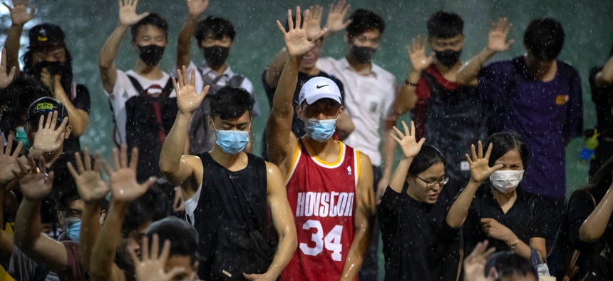 A demonstrator wearing Houston Rockets jersey holds up his hand with fellow demonstrators during a rally Hong Kong, Oct. 15, after Houston Rockets general manager Daryl Morey’s tweet in support of the Hong Kong protests sparked controversy in China.