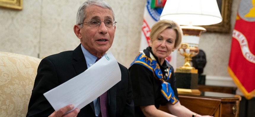 White House coronavirus response coordinator Dr. Deborah Birx listens as director of the National Institute of Allergy and Infectious Diseases Dr. Anthony Fauci speaks about the coronavirus response in the Oval Office of the White House April 29.