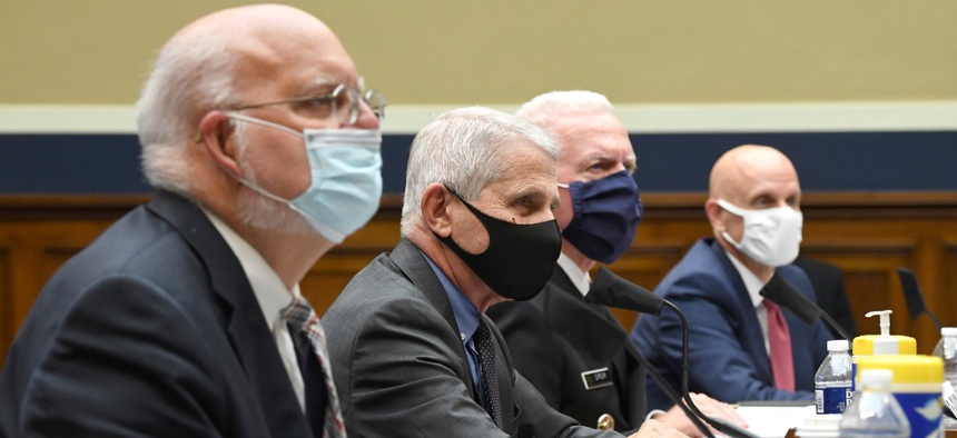 From left to right, Dr. Robert Redfield of the Centers for Disease Control and Prevention, Dr. Anthony Fauci of the National Institute for Allergy and Infectious Diseases, Adm. Brett Giroir of Health and Human Services, and Dr. Stephen Hahn of the Food an