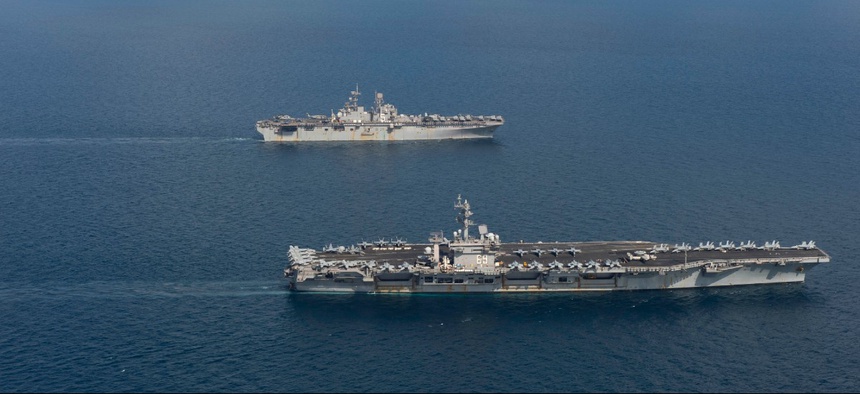 The aircraft carrier USS Dwight D. Eisenhower (CVN 69), front, the amphibious assault ship USS Bataan (LHD 5) and the amphibious transport dock ship USS New York (LPD 21) transit the Arabian Sea, April 2, 2020.