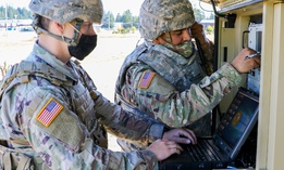 A U.S. Army signal specialist and an information technology Specialist prepare their equipment as part of the Spartan Week Convoy Operations on Sept. 29 at Joint Base Lewis-McChord, Wash. 